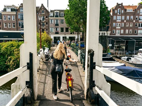Guided bike group riding through Amsterdam's canal ring
